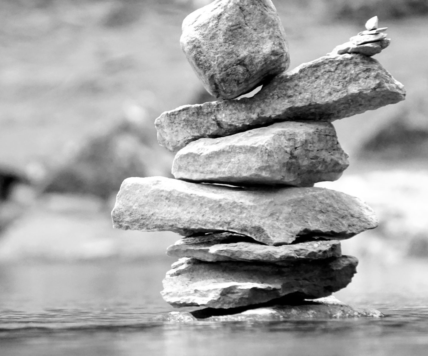 a stack of rocks on a lake in Glacier, national park, Canada